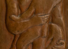 relief sculpture of woman kneeling, holding small child