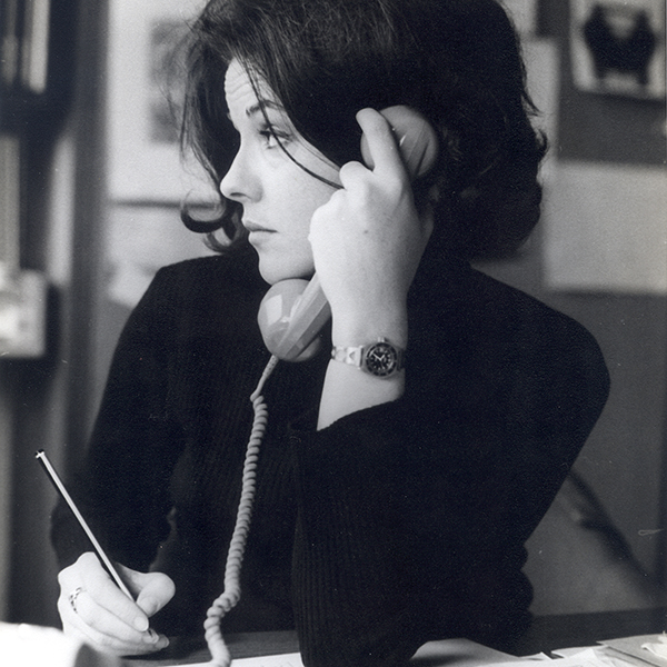 lack and white photograph of Perdita Huston on the phone taking notes