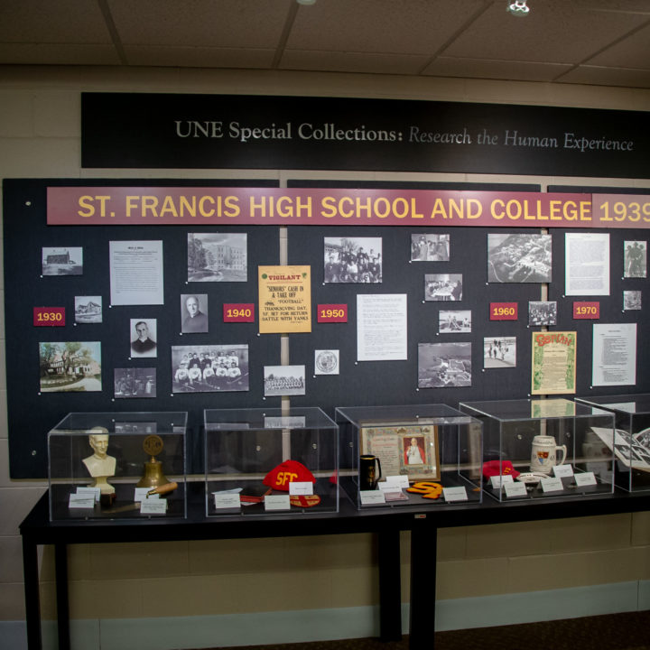 St. Francis High School and College memorabilia and photographs on display wall in Ketchum Library