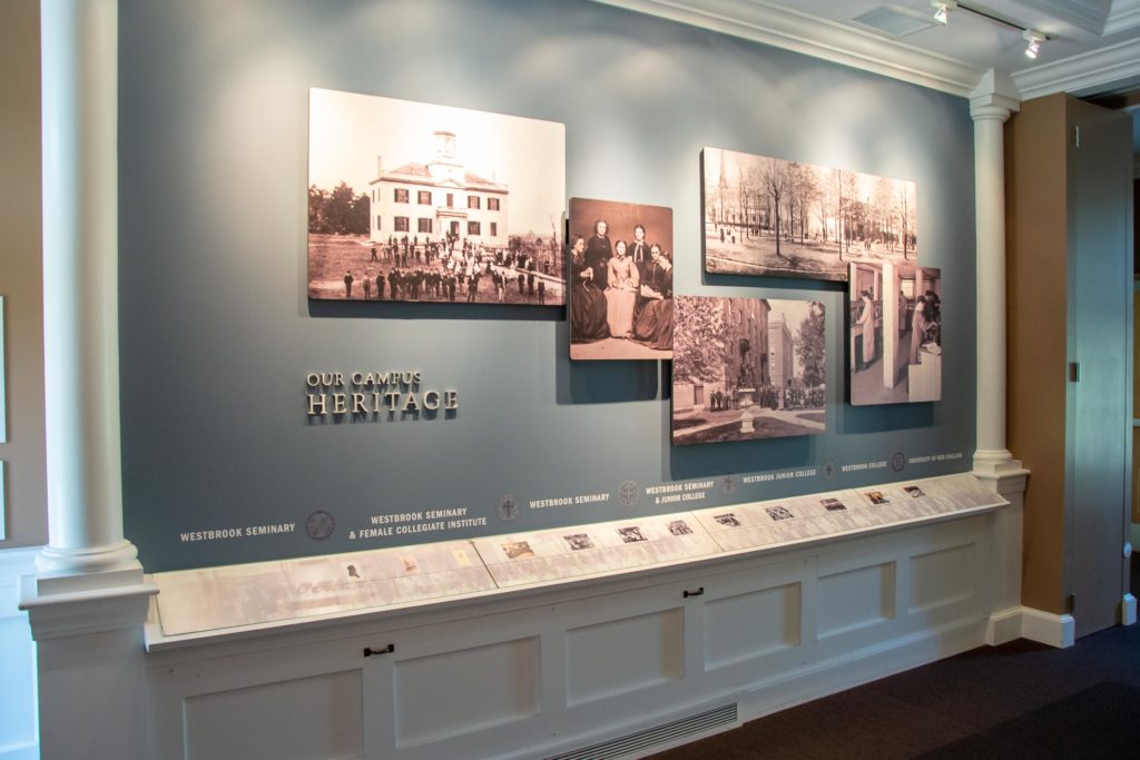 Our Campus Heritage exhibit wall with historical photos and timeline